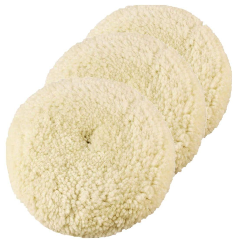 Two cream-colored wool buffing pads with center openings